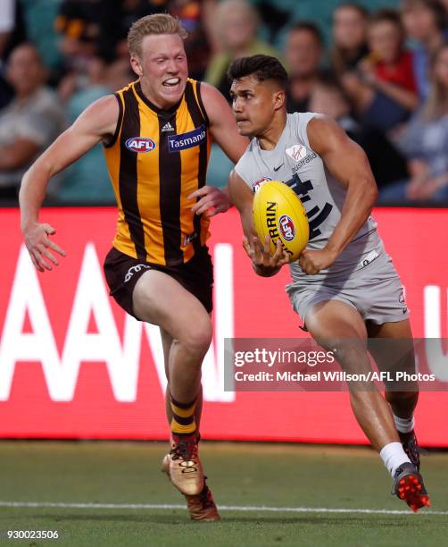 Jarrod Pickett of the Blues is chased by James Sicily of the Hawks during the AFL 2018 JLT Community Series match between the Hawthorn Haws and the...