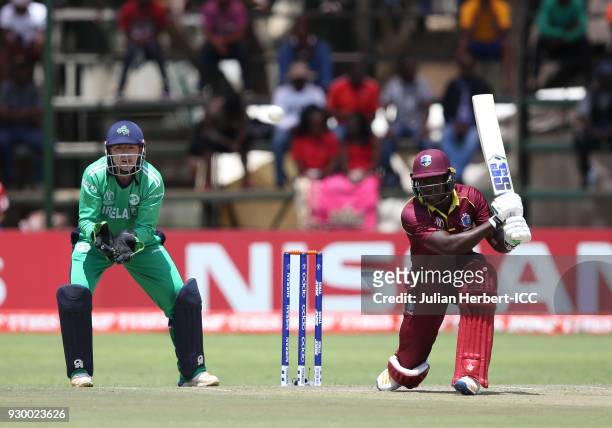 Nial Oâ Brien of Ireland looks on as Rovman Powell of The West Indies hits out during The ICC Cricket World Cup Qualifier between The West Indies and...
