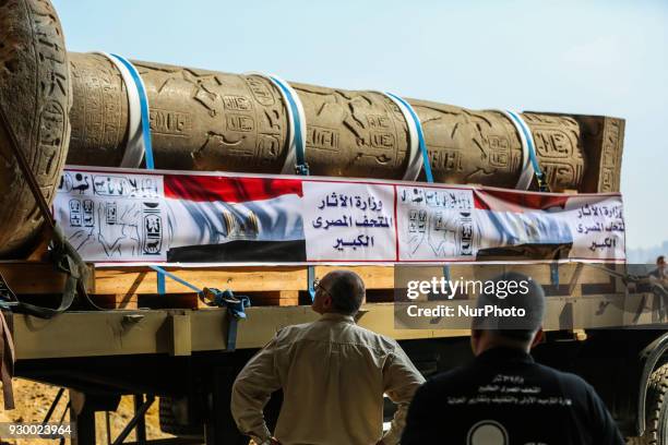 The King Merneptah pillar is loaded onto a truck to be transferred to its permanent display area at the Atrium of the Grand Egyptian Museum , near...