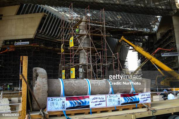 The King Merneptah pillar is loaded onto a truck to be transferred to its permanent display area at the Atrium of the Grand Egyptian Museum , near...