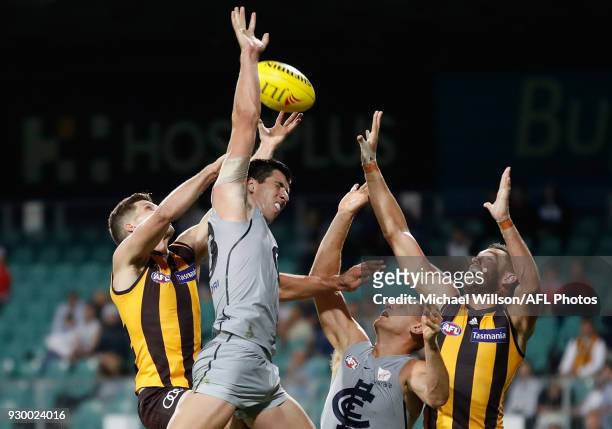 Luke Breust of the Hawks, Jacob Weitering of the Blues, Liam Jones of the Blues and Jack Gunston of the Hawks compete for the ball during the AFL...