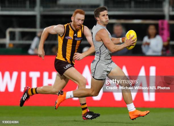 Marc Murphy of the Blues and Conor Glass of the Hawks in action during the AFL 2018 JLT Community Series match between the Hawthorn Haws and the...