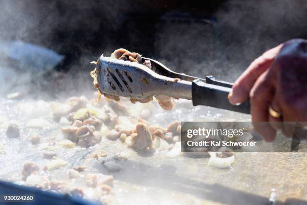 Sheep testicles, sold as mountain oysters, are prepared during the Hokitika Wildfoods Festival on March 10, 2018 in Hokitika, New Zealand.