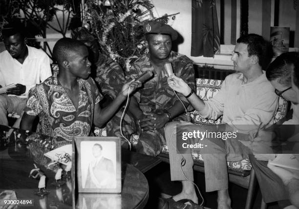 Colonel Jean-Bedel Bokassa , gives his first press conference after overthrowing president David Dacko, whose photograph is displayed on the table,...