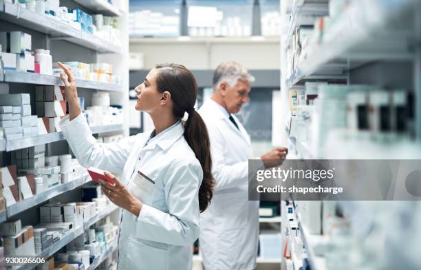 scouting the shelves for the perfect product - chemist stock pictures, royalty-free photos & images