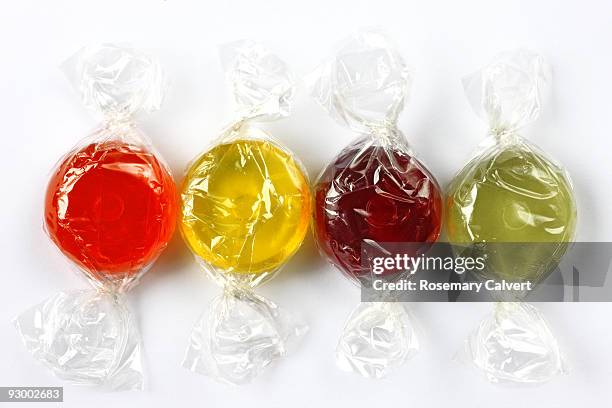 four wrapped fruit boiled sweets. - wrapped sweets stock pictures, royalty-free photos & images