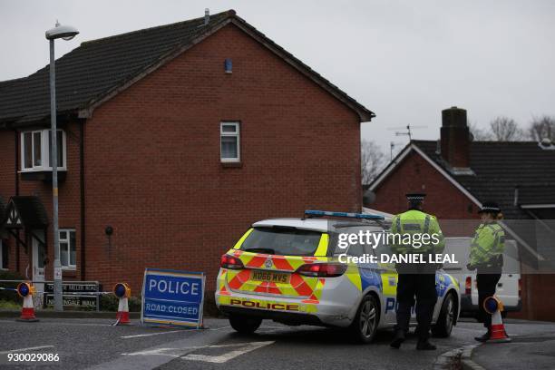 British police officers stand on duty at a cordon leading to the home of Russian spy Sergei Skripal, in Salisbury, southern England, on March 10,...