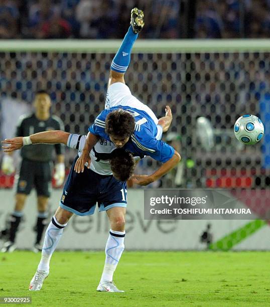 Japan's defender Daiki Iwamasa clashes with Scotland forward Lee Miller during their Kirin Challenge Cup football tournament in Yokohama on October...