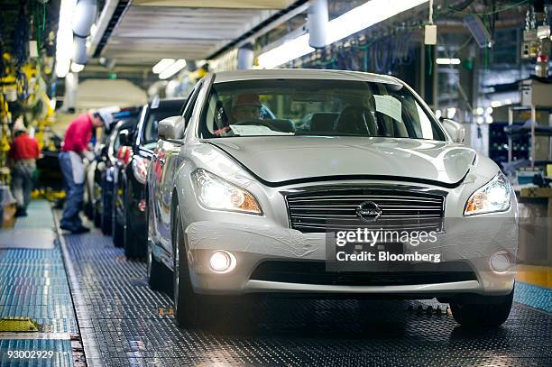 Fuga vehicles are given a final check after passing through the assembly line at Nissan Motor Co.'s Tochigi plant in Tochigi Prefecture, Japan, on...