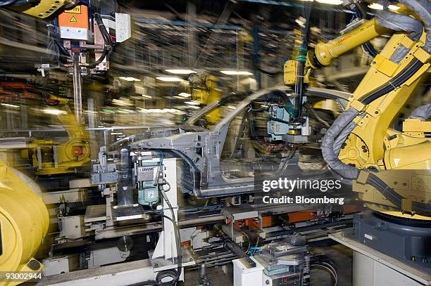 Robots work on a vehicle at Nissan Motor Co.'s Tochigi plant in Tochigi Prefecture, Japan, on Thursday, Nov. 12, 2009. A stronger yen would be a...