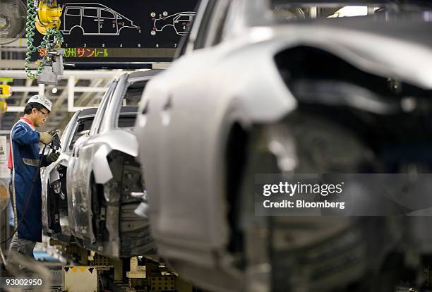 Worker assembles vehicles at Nissan Motor Co.'s Tochigi plant in Tochigi Prefecture, Japan, on Thursday, Nov. 12, 2009. A stronger yen would be a...