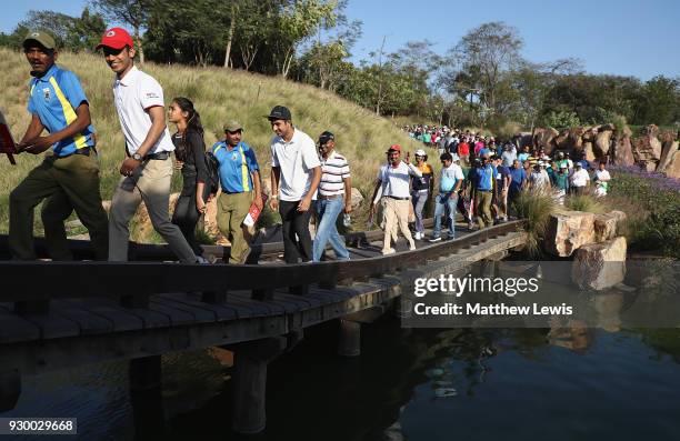 Crowds walk onto the 17th fairway during day three of the Hero Indian Open at Dlf Golf and Country Club on March 10, 2018 in New Delhi, India.