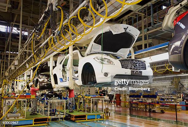 Workers assemble vehicles at Nissan Motor Co.'s Tochigi plant in Tochigi Prefecture, Japan, on Thursday, Nov. 12, 2009. A stronger yen would be a...