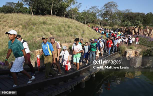 Crowds walk onto the 17th fairway during day three of the Hero Indian Open at Dlf Golf and Country Club on March 10, 2018 in New Delhi, India.