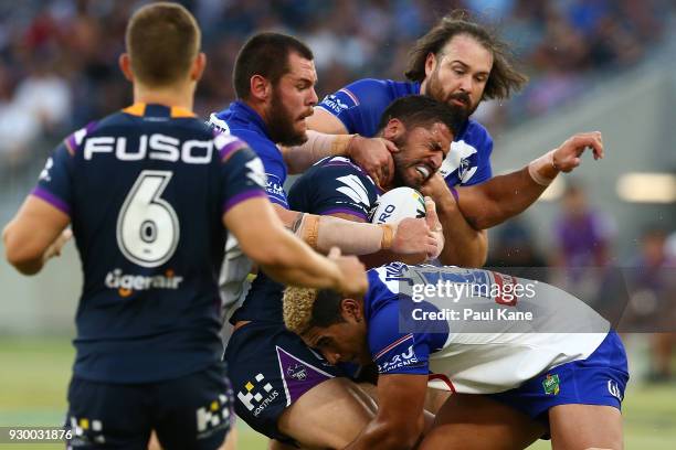 Jesse Bromwich of the Storm gets tackled during the round one NRL match between the Canterbury Bulldogs and the Melbourne Storm at Optus Stadium on...