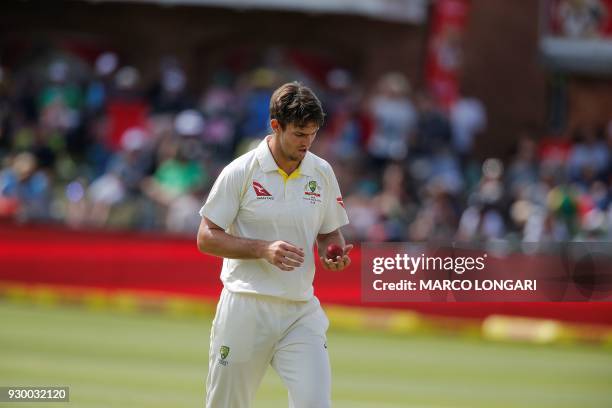 Australia's bowler Mitchell Marsh prepares to deliver a ball during day two of the second Sunfoil Cricket Test match between South Africa and...