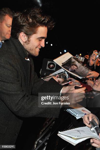 Actor Robert Pattinson signs autographs at The Twilight Saga: New Moon, UK fan event at Battersea Evolution on November 10, 2009 in London, England.