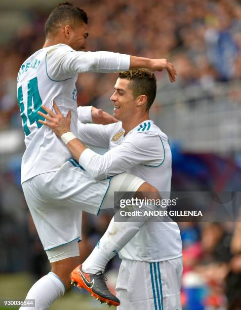 Real Madrid's Portuguese forward Cristiano Ronaldo celebrates with Real Madrid's Brazilian midfielder Casemiro after scoring a goal during the...