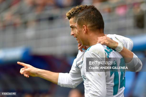 Real Madrid's Portuguese forward Cristiano Ronaldo celebrates with Real Madrid's Brazilian midfielder Casemiro after scoring a goal during the...