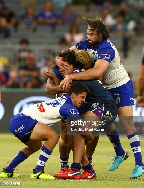 Felise Kaufusi of the Storm gets tackled during the round one NRL match between the Canterbury Bulldogs and the Melbourne Storm at Optus Stadium on...