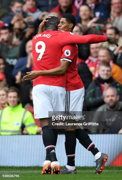 Marcus Rashford celebrates scoring his side's first goal with Romelu Lukaku of Manchester United during the Premier League match between Manchester...