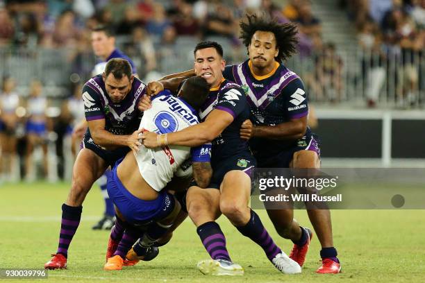 Aaron Woods of the Bulldogs is tackled during the round one NRL match between the Canterbury Bulldogs and the Melbourne Storm at Optus Stadium on...