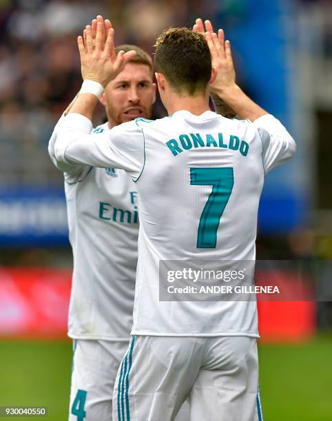 Real Madrid's Portuguese forward Cristiano Ronaldo celebrates with Real Madrid's Spanish defender Sergio Ramos after scoring a goal during the...