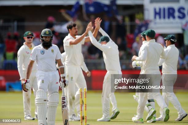 South Africa's batsman Hashim Amla leaves the ground after having been dismissed by Australia bowler Mitchell Starc during day two of the second...