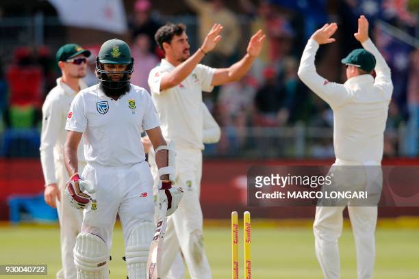 South Africa's batsman Hashim Amla leaves the ground after having been dismissed by Australia bowler Mitchell Starc during day two of the second...