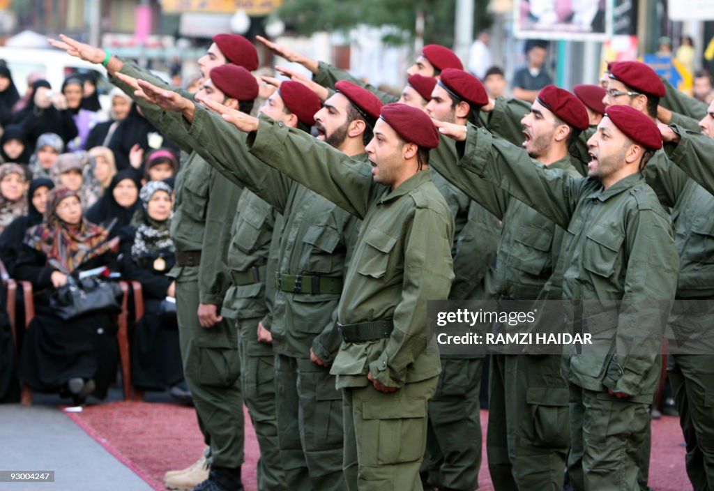 Hezbollah fighters parade during a cerem