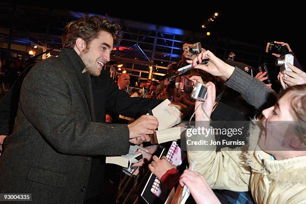 Actor Robert Pattinson signs autographs at The Twilight Saga: New Moon, UK fan event at Battersea Evolution on November 10, 2009 in London, England.