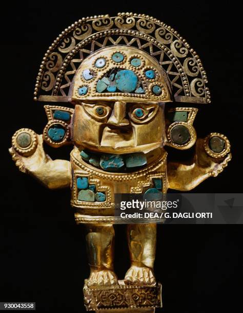 Handle of a sacrificial knife , depicting a deity set with turquoise, Moche or Mochica culture, Peru.