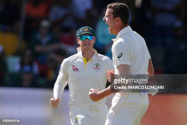 Australia's bowler Josh Hazlewood celebrates taking the wicket of South Africa's batsman Dean Elgar during day two of the second Sunfoil Cricket Test...