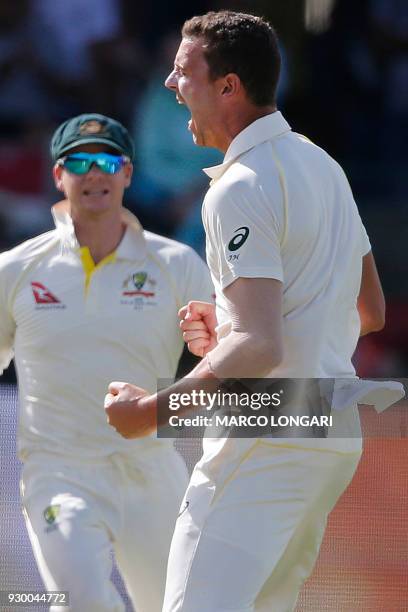 Australia's bowler Josh Hazlewood celebrates taking the wicket of South Africa's batsman Dean Elgar during day two of the second Sunfoil Cricket Test...