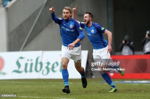 Tim Vaeyrynen of Rostock jubilates with team mate Pascal Breier after scoring the first goal during the 3.Liga match between FC Hansa Rostock and SC...