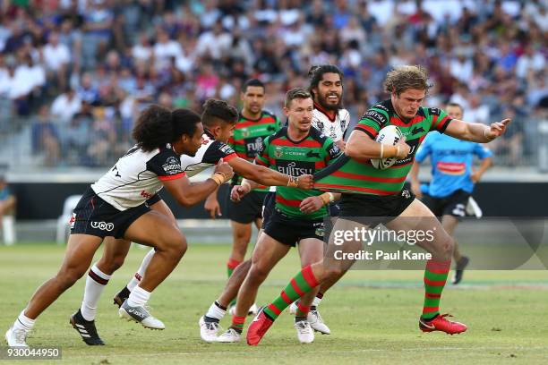 George Burgess of the Rabbitohs attempts to break from a tackle during the round one NRL match between the South Sydney Rabbitohs and the New Zealand...