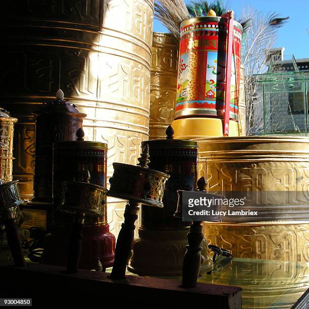 large and small prayer wheels - lucy lambriex stock-fotos und bilder