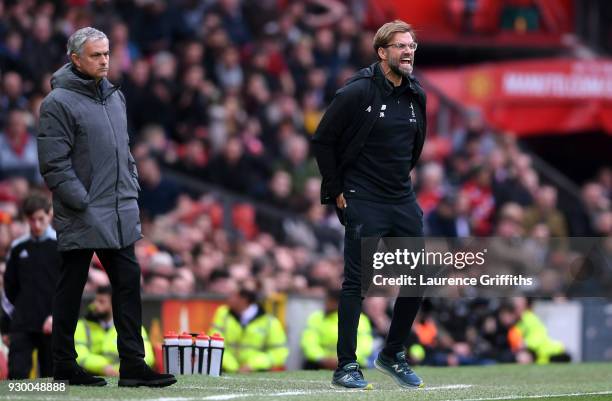 Jurgen Klopp, Manager of Liverpool reacts as Jose Mourinho, Manager of Manchester United looks on during the Premier League match between Manchester...