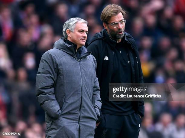 Jose Mourinho, Manager of Manchester United and Jurgen Klopp, Manager of Liverpool speak during the Premier League match between Manchester United...