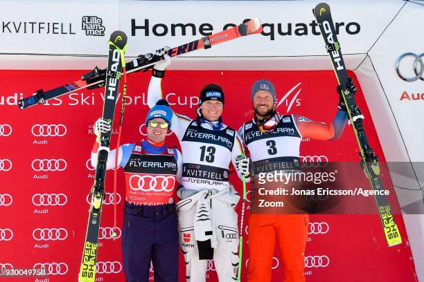 Beat Feuz of Switzerland takes 2nd place, Thomas Dressen of Germany takes 1st place, Aksel Lund Svindal of Norway takes 3rd place during the Audi FIS...