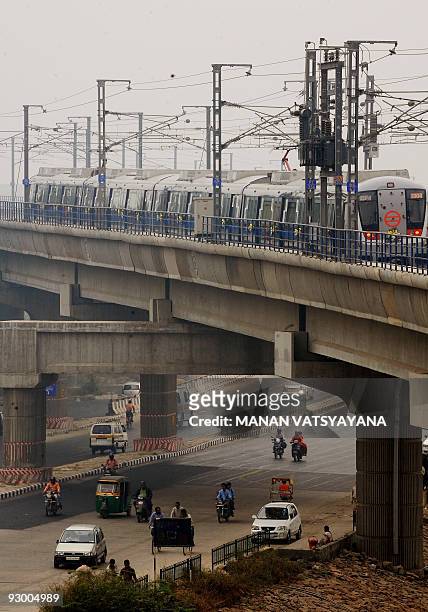 New metro train leaves for Noida from the Akshardham Metro Station in New Delhi on November 12, 2009. Delhi Metro Rail Coorporation held a ceremonial...