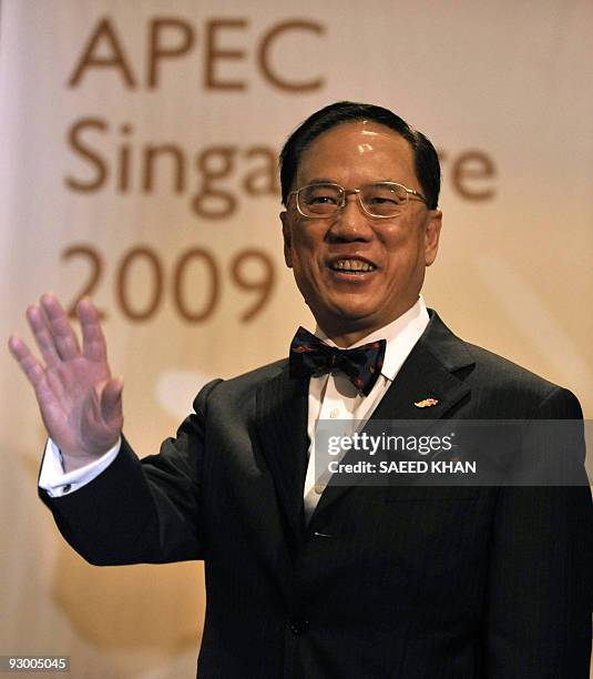 Hong Kong Chief Executive Donald Tsang waves as he leaves Changi Airport VIP complex in Singapore on November 12 upon his arrival to attend The...