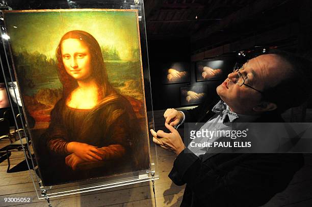 French engineer and founder of Lumiere Technology, Pascal Cotte explains his work in the 'Secrets of the Mona Lisa' section during a press view of...