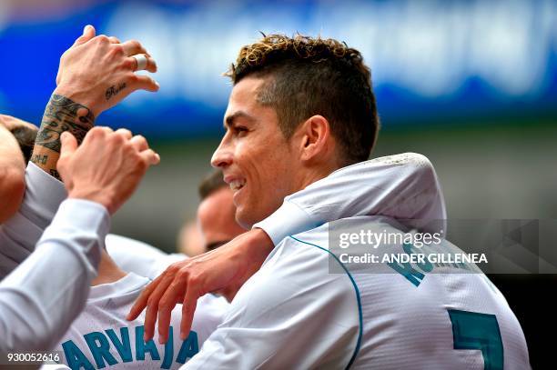 Real Madrid's Portuguese forward Cristiano Ronaldo celebrates with teammates after scoring his team's second goal during the Spanish league football...