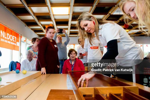 Queen Maxima of The Netherlands volunteers during the NL Doet at residential care centre 't Hofland in Pijnacker on March 10, 2018 in Pijnacker,...
