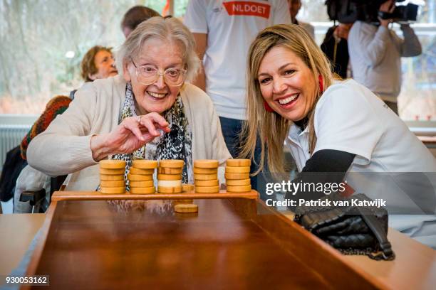 Queen Maxima of The Netherlands volunteers during the NL Doet at residential care centre 't Hofland in Pijnacker on March 10, 2018 in Pijnacker,...