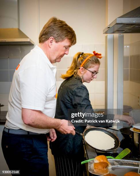 King Willem-alexander of The Netherlands volunteers during the NL Doet at residential care centre 't Hofland in Pijnacker on March 10, 2018 in...