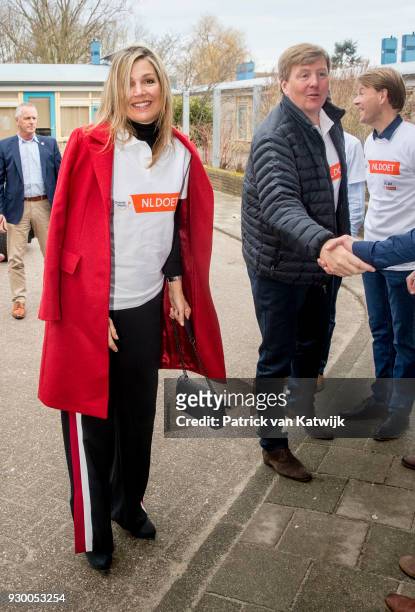 King Willem-alexander of The Netherlands and Queen Maxima of The Netherlands arrive to volunteer during the NL Doet at residential care centre 't...