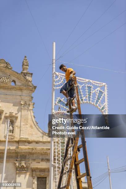 mounting traditional lights called luminarie for san pietro e paolo festivity - luminarie photos et images de collection