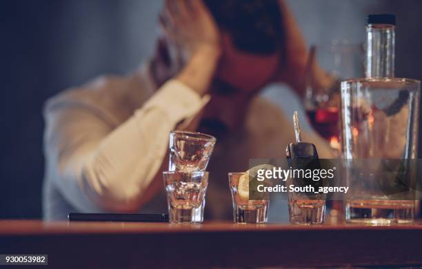 man drinking in bar - binge drinking stock pictures, royalty-free photos & images